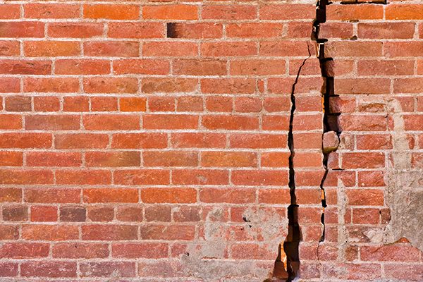 Red brick wall with cracks