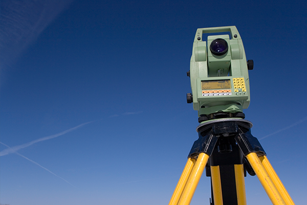 An image of some survey equipment with a blue sky behind it