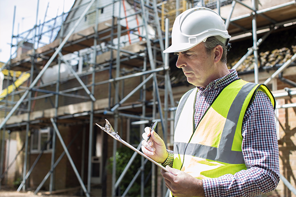 An image of an inspector inspecting a house